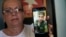 Marilin Vinent holds up a photo of her son Dannys Castillo, uno de los cubanos reclutados para luchar por Rusia en Ucrania. (Foto AP/Ramón Espinosa)