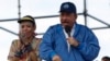 El presidente de Nicaragua, Daniel Ortega, habla a sus seguidores, junto a su esposa y vicepresidenta Rosario Murillo. (AP Foto/Alfredo Zuniga)