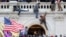 Una turba de simpatizantes del expresidente Donald Trump lucha contra policías en la puerta que rompieron al asaltar el Capitolio en Washington D.C. el 6 de enero pasado.