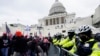 Partidarios de Trump intentan romper una barrera policial en el Capitolio, en Washington. (AP Photo/Julio Cortez)